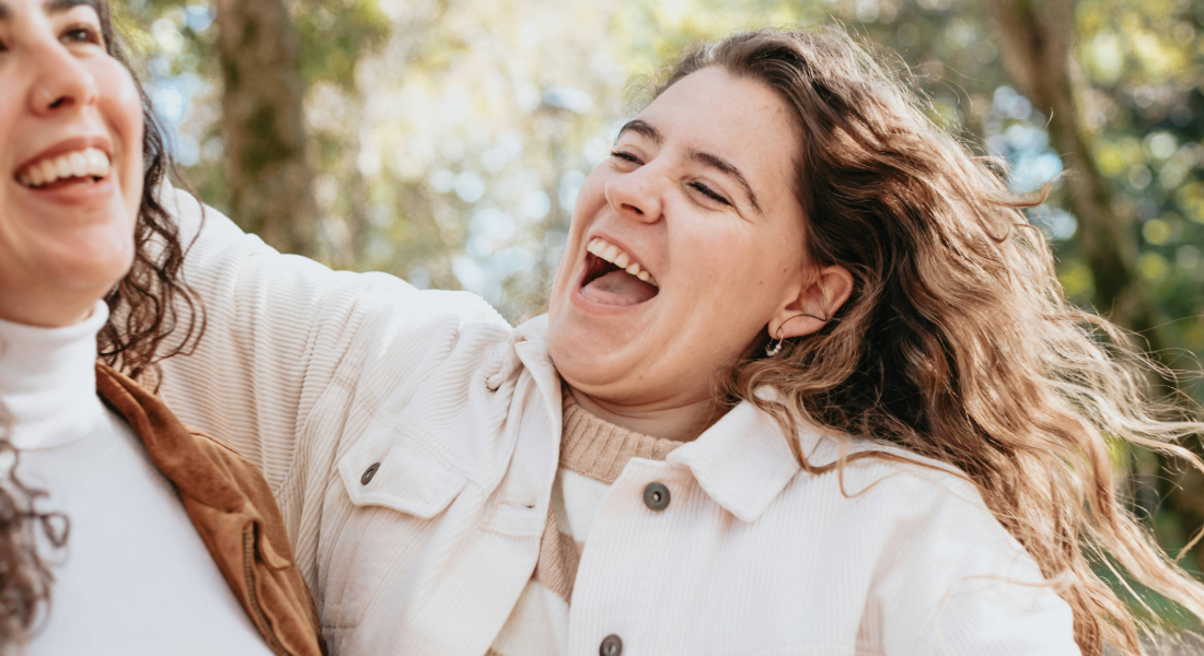 Two women smiling outdoors