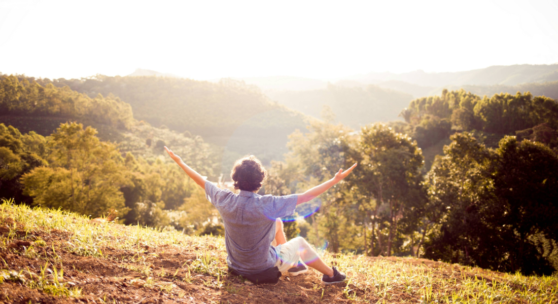 Man sitting on a hilltop
