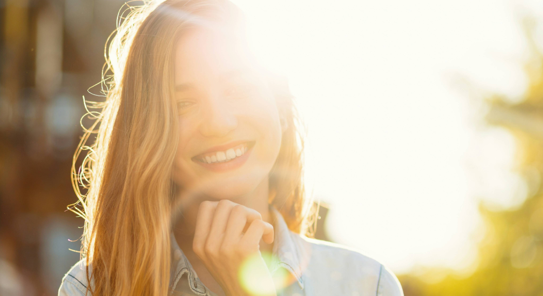woman with sunshine behind her